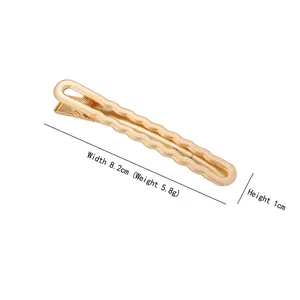 Minimalist gold wave metal hair clip with matte finish for a stylish daily hair styling