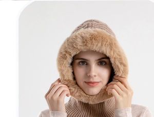 Detail of knitted winter hood with thick faux fur trim and integrated neck warmer