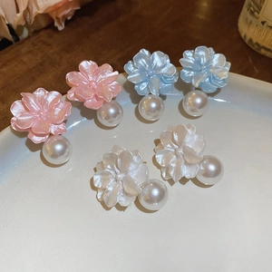 Detailed view of pastel resin flower earrings with pearl pendants in multiple colors