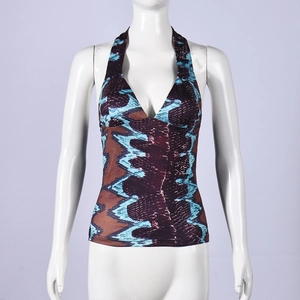 Detail of deep V-neck halter top featuring vibrant blue and purple snake print fabric