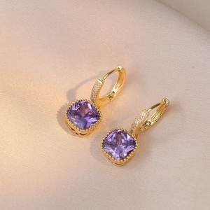 Elegant gold huggie earrings featuring purple princess cut crystals and white zircon