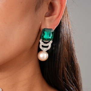 Close-up of geometric emerald gemstone earring with pavé zircon and round pearl drop