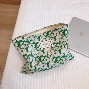 Detail view of cotton leaf print cosmetic bag with Time to Party patch and metal zipper