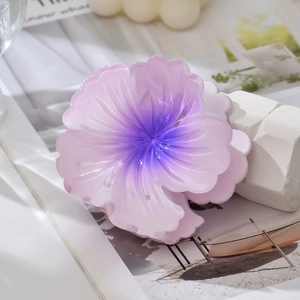 Detail shot of a gradient purple flower hair claw clip with a glossy resin finish