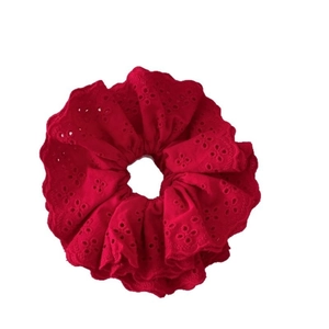 Elegant red lace embroidery scrunchie hair tie with intricate eyelet pattern detailing