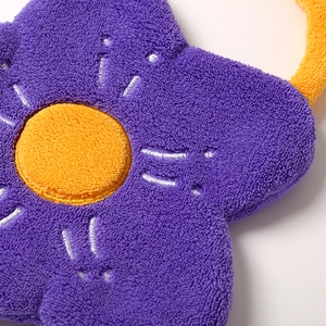 Close-up of a floral hand towel with purple petals and yellow center in coral velvet