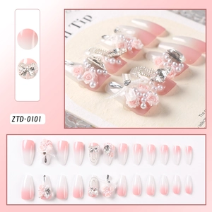 Macro detail of long coffin press-on nails with 3D resin roses, pearls, and crystals