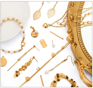 Flat lay of 18K gold plated copper jewelry components with white pearls and gold accents