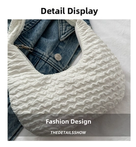 Detail shot of the white pleated textured shoulder bag with soft cloud-like bubble fabric