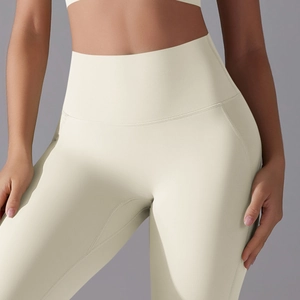 Detailed side view of high-waisted cream yoga leggings with ergonomic stitching