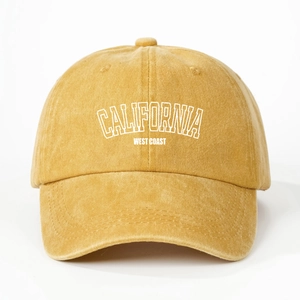 Detailed close-up of yellow washed cotton baseball cap with white CALIFORNIA embroidery