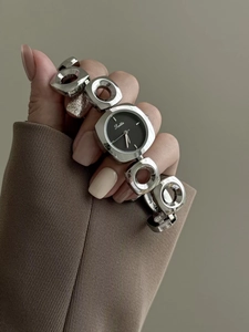 Detail of silver link bracelet watch for women with square black dial and minimalist design