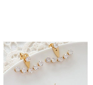 Detailed macro view of 18K gold-plated ear jackets with sparkling circular zircons