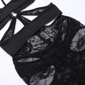Close-up of intricate black lace patterns and sheer mesh stitching on sexy bodysuit