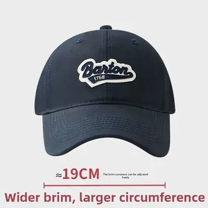 Detail showing 19cm wide adjustable curved brim of this navy blue baseball cap