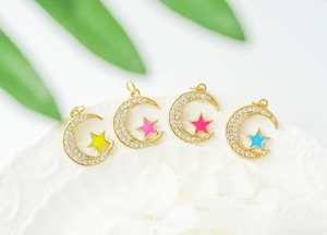 Detailed close-up of 18K gold plated moon pendants with zircons and colorful enamel stars