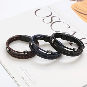 Detail of multi-layer braided leather bracelets with matte black magnetic clasps and silver beads