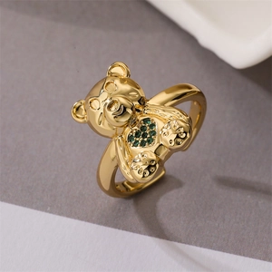 Detailed close-up of golden bear ring featuring a green heart zircon and adjustable band