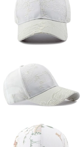Macro detail of delicate floral embroidery on white breathable summer baseball cap