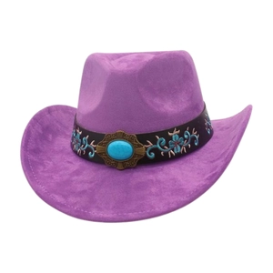 Detail of purple cowboy hat featuring turquoise stone and floral embroidered leather band