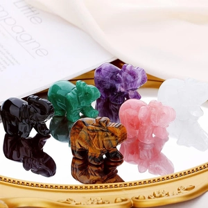 Natural crystal elephant figurines in assorted gemstones on a decorative tray