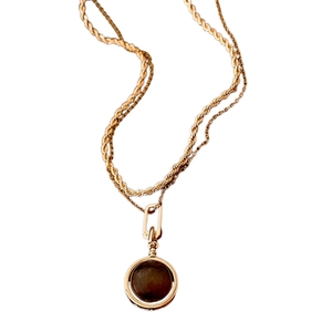 Double-layered gold twisted chain necklace with a round dark faux tiger eye pendant