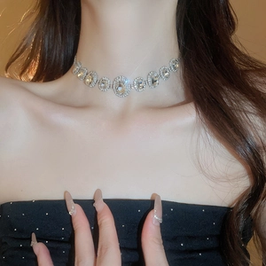 Close-up of a silver-tone necklace set with large oval and small round clear crystals