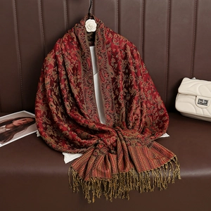 Detailed close-up of red paisley pattern and fringe on luxury cashmere-like pashmina shawl