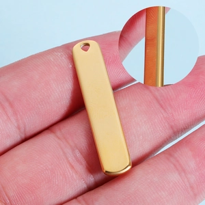 Detail of gold rectangular stainless steel bar pendant with hole for custom engraving
