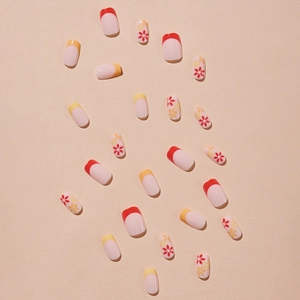 Press-on nails set with red and yellow French tips and daisy patterns on pink base