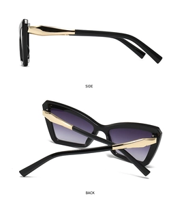 Detail view of retro cat-eye sunglasses featuring golden geometric metal temples and lenses