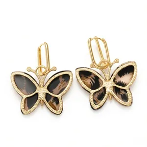 Golden butterfly earrings with tortoiseshell leopard pattern and beaded metal edges