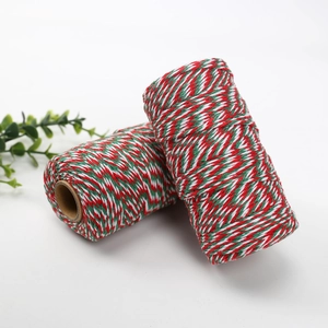 Detail of red green and white Christmas cotton twine rolls on kraft paper core