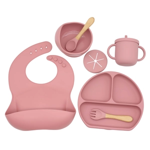 Complete pink silicone baby feeding set with suction plate, bib, bowl, and straw cup
