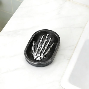Gothic skull hand soap holder on white marble countertop showing textured resin detail