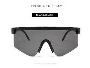 Detail of matte black sports sunglasses with white dotted textures and gray lenses