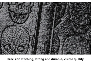 Detailed close-up of skull embossed pattern and reinforced stitching on black leather tote