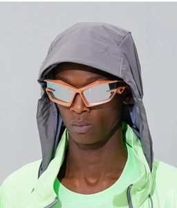 Close-up of futuristic Y2K geometric mirror sunglasses with pink gold metallic frame
