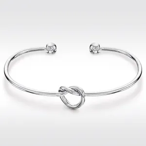 Polished silver stainless steel knot open bangle bracelet with spherical end accents