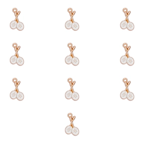 Detailed view of rose gold tennis racket charms with white enamel for DIY jewelry making
