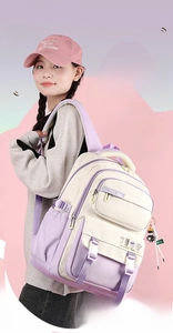Detail of color-block college backpack with functional pockets and cartoon charm