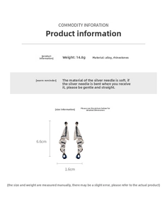 Detail view of silver earrings with blue rhinestones and 6.6cm x 1.6cm dimensions
