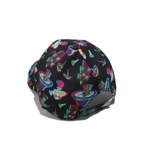 Close-up of baseball cap featuring colorful mushroom prints on black cotton canvas fabric