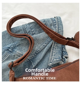 Close-up of brown corduroy dumpling bag texture with shoulder strap and adjustable buckle