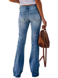 Slim fit flared blue jeans with whiskers design and back view on model with handbag