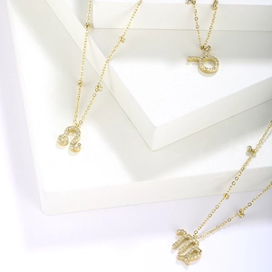 Gold plated stainless steel zodiac necklaces with sparkling zircon inlaid symbols