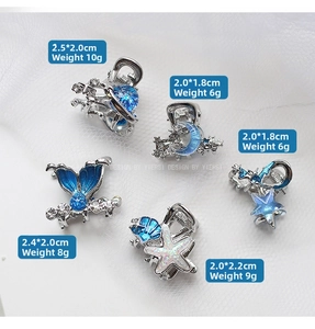 Dettaglio di cinque mini mollette in lega con design di stelle marine e luna blu