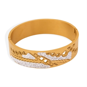 18K gold plated titanium steel cuff bracelet with hollow flower design and white rhinestones