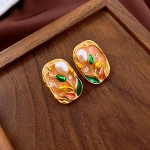 Detail of vintage oil painting style earrings with pink enamel tulips and baroque pearls