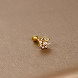 Detailed macro view of gold flower cartilage stud with 13 clear cubic zirconia crystals